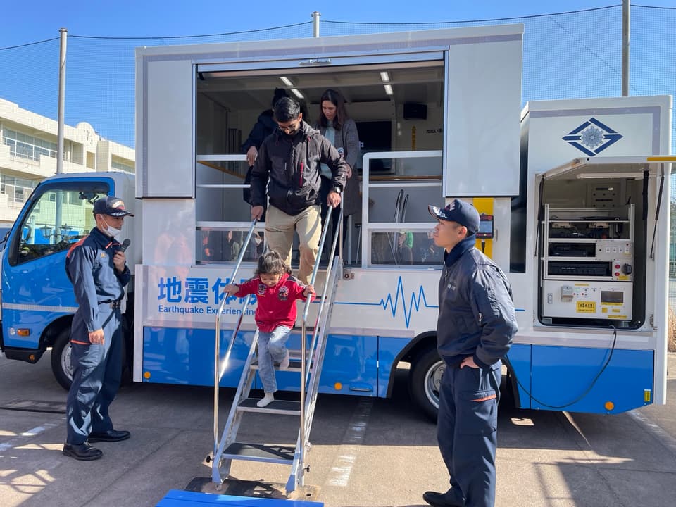 Participants step out of the Yokohama fire bureau earthquake-simulation vehicle during the ReadyJapan winter visit