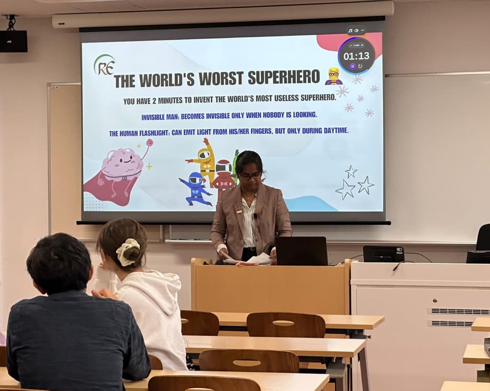 A REarth facilitator leads an interactive climate education session with students at Sophia University